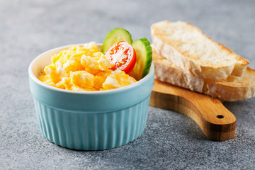 Scrambled eggs with tomato and cucumber