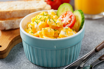 Scrambled eggs with tomato and cucumber