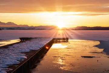 Fototapeta premium romantic sunset over a frozen lake