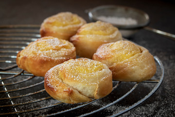 Small vaanilla snails with icing sugar on a cake rack