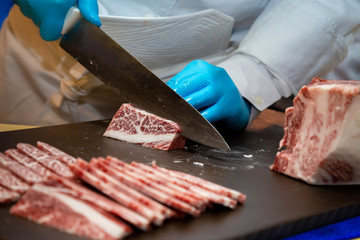 butcher or chef are cutting and decorating highest  meat grade of marbling A5 japanese wagyu beef...