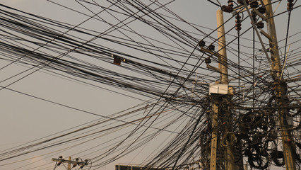 Communication lines that look cluttered on electrical poles, Look disorganized.
