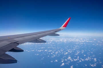 Fototapeta na wymiar Aeroplane wing view from window beautiful sky. Traveling concept