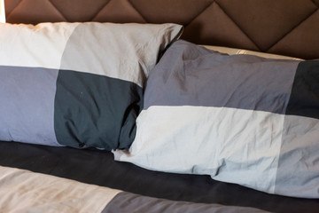 Fototapeta na wymiar Natural soft pillows on comfortable bed at home
