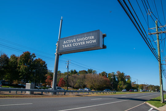 Electronic Sign Over Highway That Says, Active Shooter Take Cover Now.