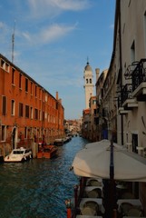 Fototapeta premium View of the Rio Marin Canal with boats and gondolas from the Ponte de la Bergami in Venice, Italy. Venice is a popular tourist destination of Europe.