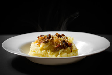 mashed potatoes with meat on a white plate