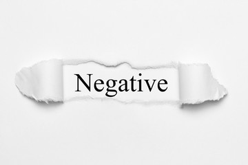 Negative on white torn paper