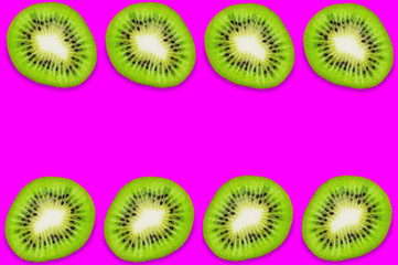 Two rows of four pieces of fresh ripe kiwi on pink background with copy space for your text