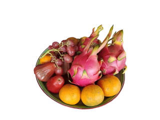 Dragon fruit, orange, grape and rose apple in plate isolate on white background.