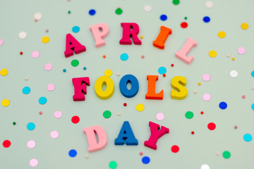 inscription April Fools Day in colorful bright wooden letters on a blue background with a holiday...
