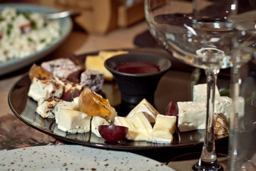 Delicious dishes on the table in the restaurant. serving table. Different kinds of cheese with honey on a plate.