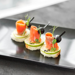 Delicious appetizers with red fish and lime and sesame. Concept of food, restaurant, catering, menu.