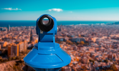 City of Barcelona panoramic view seen through a blue touristic telescope's eyepiece