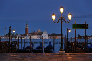 Fototapeta na wymiar Church of San Giorgio Maggiore with gondolas at night, Venice, Italy 