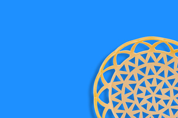 One empty circular plastic beige basket on blue table. Copy space for your text. Top view