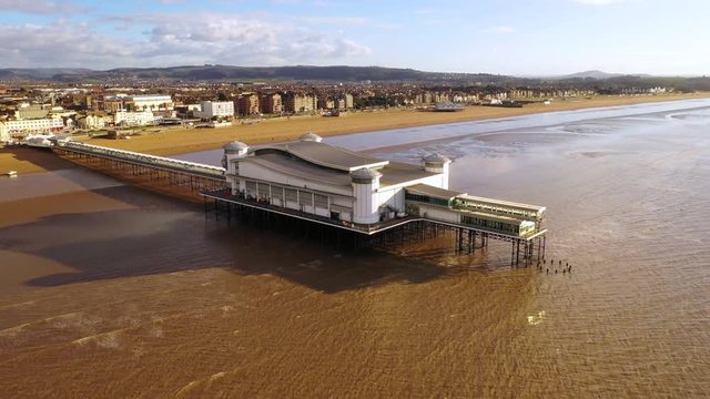 Aerial sequence depicting the Grand Pier, Weston-super-Mare, Somerset. Built in the late 1890's. Well maintained and modernised, a popular tourist pleasure attraction and setting for many TV shows