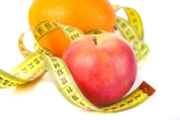 Apples and orange with measure tape on white background, healthy diet