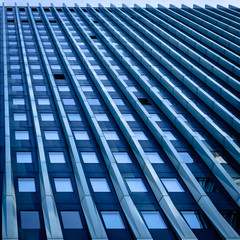 Straight up the facade of a very tall office building with linear design elements