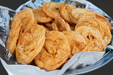 Round flat crispy pastries at an street eatery in Ban Pong, Thailand
