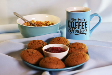cup of coffee and cookies on table