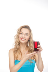 Beautiful, smiling, young girl holding a glass of cherry juice