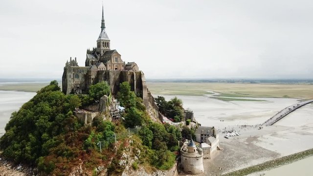 Aerial Tilt: Mont Saint Michael Visited by Tourists on a Beautiful Day