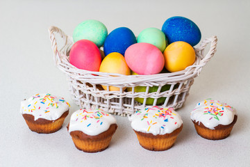 Fototapeta na wymiar Delicious cupcakes and painted eggs for Easter Celebration