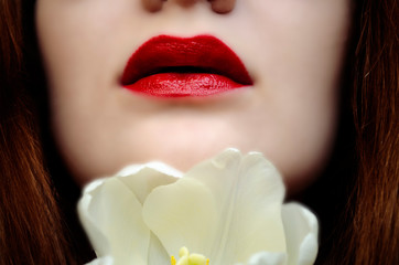 women with red lips and white flower