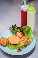 burger with french fries and salad