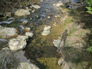 shadow of a man on a bridge reflected on a flowing stream 