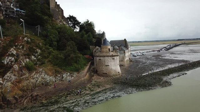 Aerial Backward: Majestic Old Castle of Mont Saint Michael Isolated by Water