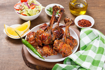 Grilled chicken legs with spices. Turkish Pirzola Kebab .