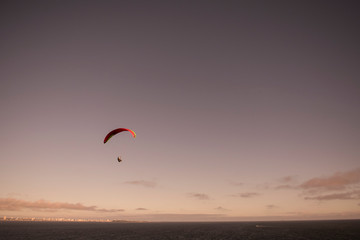 silhouette of a paraglider in the sunset