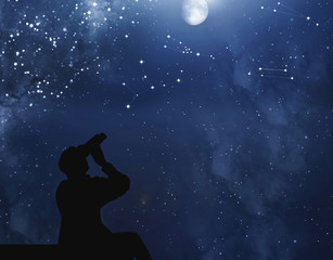 The man on the roof looks through his binoculars at the full moon and starry sky with constellations at night