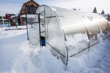Polycarbonate greenhouse in winter. Western Siberia