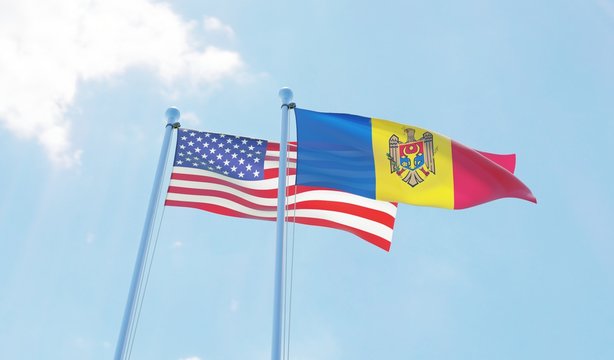 Moldova and USA, two flags waving against blue sky. 3d image