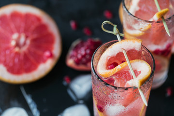 Grapefruit and pomegranate cocktail or mocktail, refreshing summer drink with crushed ice