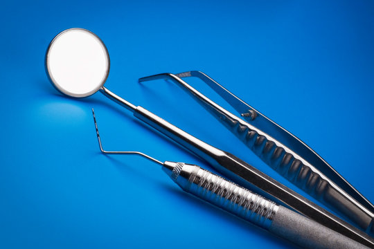 Professional dentist tools on blue background. Dental Care background. - Image