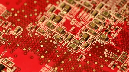 Circuit board with components in rotation. Close up of red electronic board, with components. - Powered by Adobe