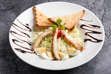 fresh tasty caesar salad appetizer in white plate
