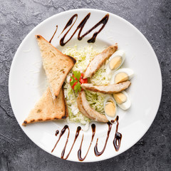 fresh tasty caesar salad appetizer in white plate