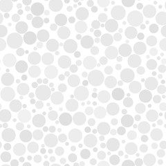Abstract seamless pattern of circles of different sizes in white and gray colors