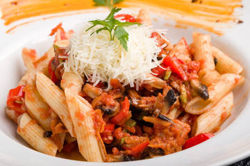 tasty vegetarian penne pasta in white plate