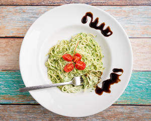 tasty spinach with spaghetti pasta on white plate