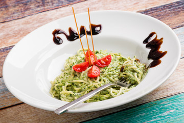 tasty spinach with spaghetti pasta on white plate