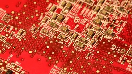 Circuit board with components in rotation. Close up of red electronic board, with components.