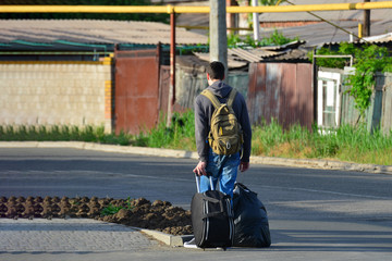 People with bags go to the station to move to another place to work after the holidays.