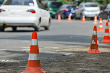 Road orange conical sign on the repair of the road in the city.