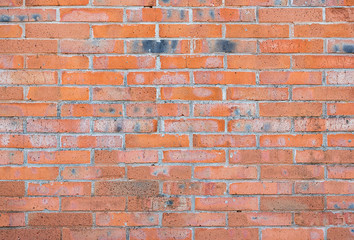 Red brick wall. Abstract background texture of old brick. Vintage wallpaper with horizontal stone blocks.